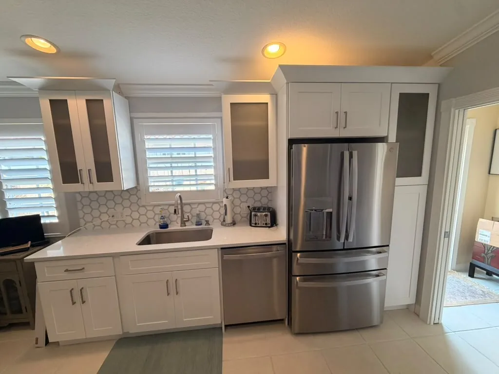 Renovated kitchen with white cabinets and new countertops